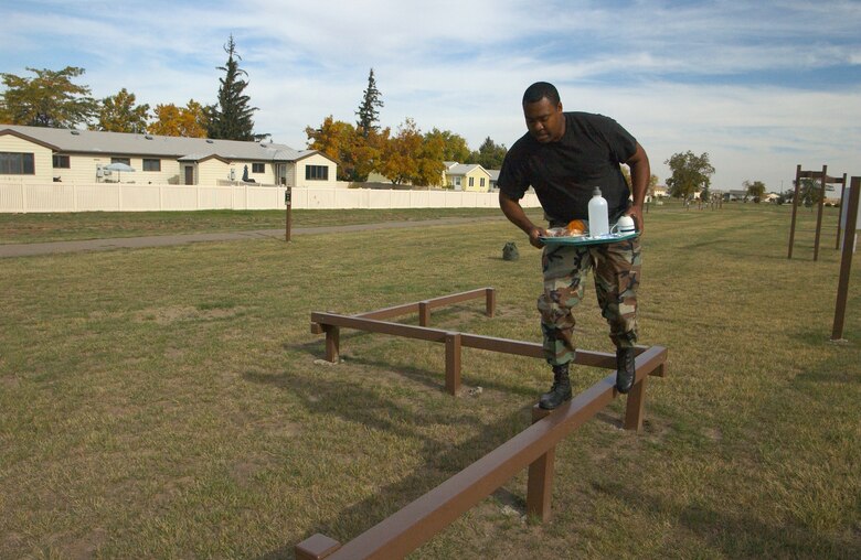 Staff Sgt. Jamari Austin, a 564th Missile Squadron chef, balances his breakfast while navigating the course during the Line Swine Competition Sept. 29.