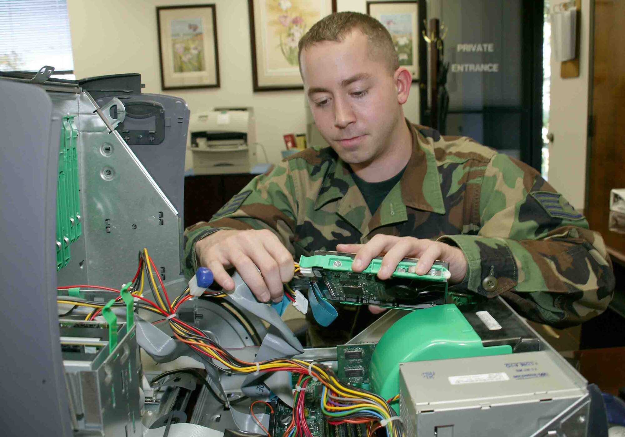 Staff Sgt. Travis Bingham, 20th Fighter Wing functional systems administrator, replaces a crashed hard drive on a government computer. (U.S. Air Force photo/Senior Airman John Gordinier)