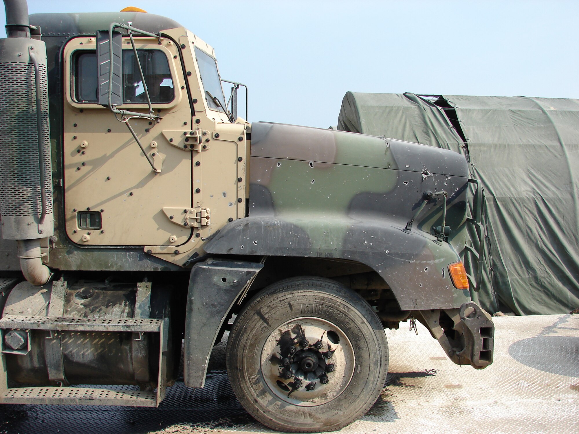 Staff Sgt. Franklin Woods, 43rd Logistics Readiness Squadron, deployed as convoy support during a previous air expeditionary rotation. During a routine transport mission, his vehicle, an M195 tractor trailor, was hit by an improvised explosive device. Because the IED detonated just feet from the convoy, shrapnel penetrated the engine block inflicting major damage to the undercarriage but did not damage the cab where Airmen were sitting. (Courtesy photo)
