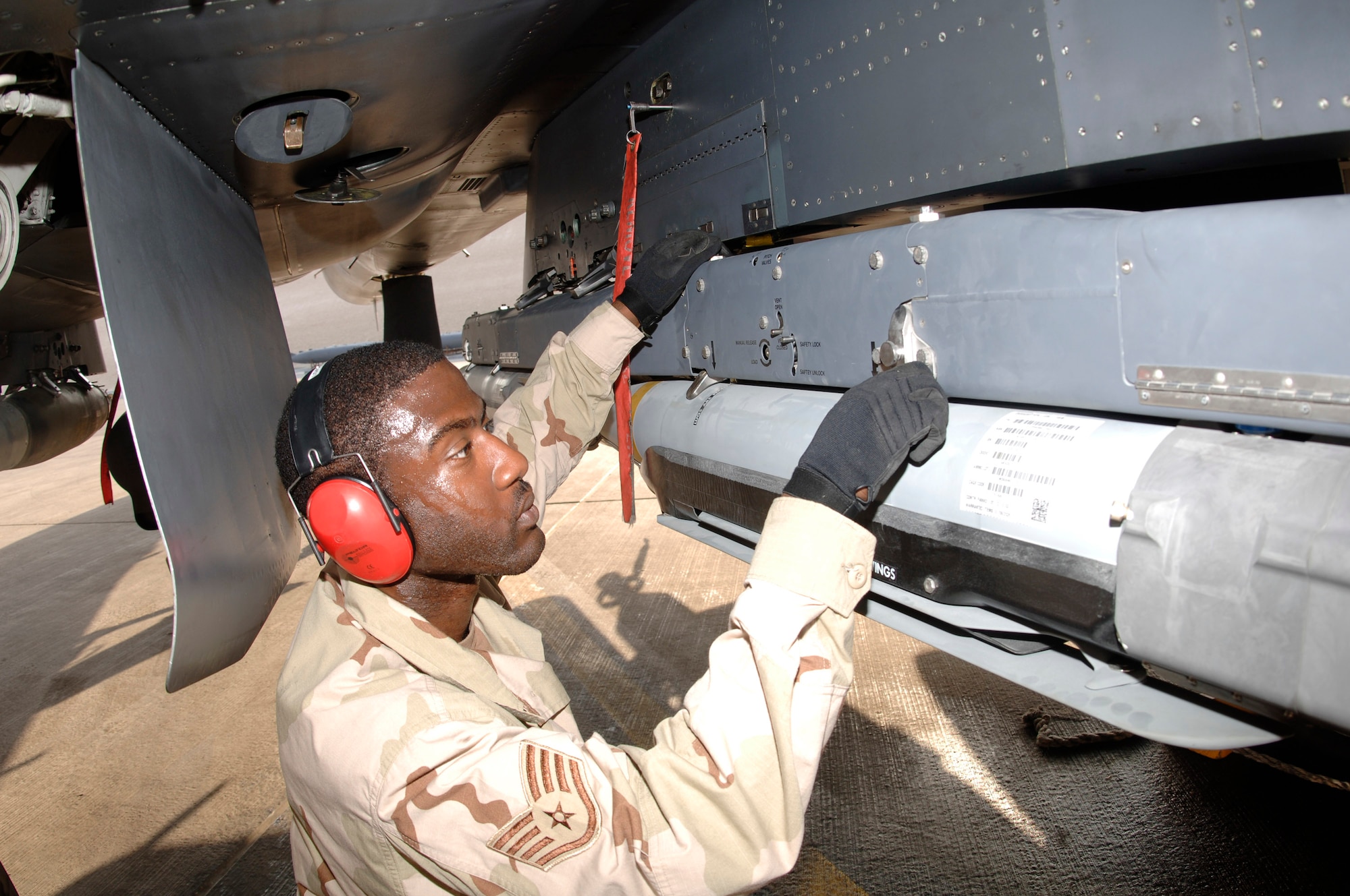 Staff Sgt. Kevin Harvey secures a weapons carriage with GBU-39/B small diameter bombs to an F-15E Strike Eagle. Sergeant Harvey is assigned to the 379th Expeditionary Aircraft Maintenance Squadron. He is deployed from Royal Air Force Lakenheath, England, in support of Operation Iraqi Freedom. (U.S. Air Force photo/Senior Airman Ricky Best) 