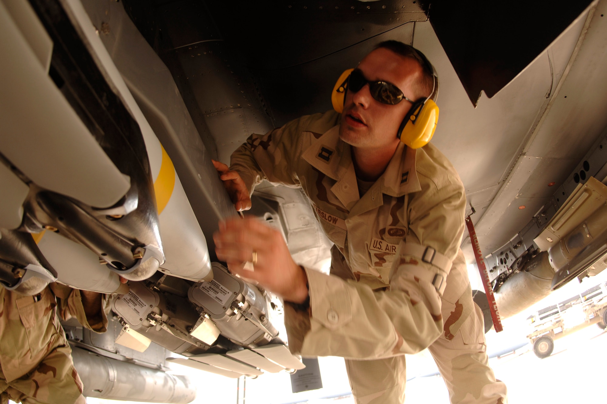 Capt. Jim Parslow, Small Diameter Bomb Systems Flight commander, inspects a weapons carriage with GBU-39/B small diameter bombs mounted on an F-15E Strike Eagle. Captain Parslow is deployed to a forward-operating location from the Air Armament Center at Eglin Air Force Base, Fla., to support the fielding of the SDB and to ensure a smooth transition from the weapon testing to combat operations. (U.S. Air Force photo/Senior Airman Ricky Best) 