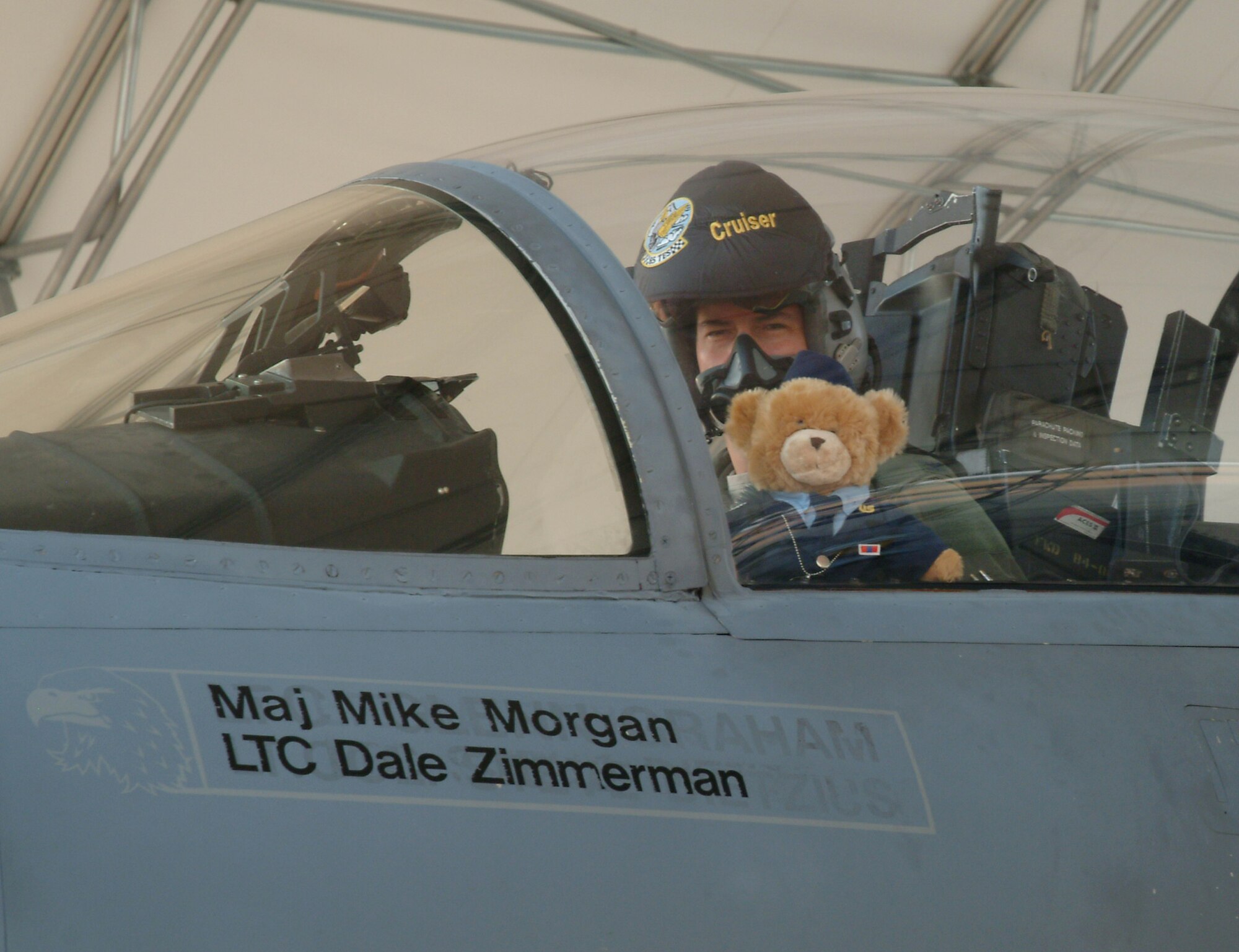 Colonel Wilsbach, preps his wingman, “Super Hero” for an F-15 sortie Wednesday morning.  The bear joined the wing Sept. 29 after Bailey Reese presented it to Colonel Wilsbach during the Celebrate Freedom ceremony at Longwood Elementary. (U.S. Air Force photo by Staff Sgt. Samuel King Jr.)