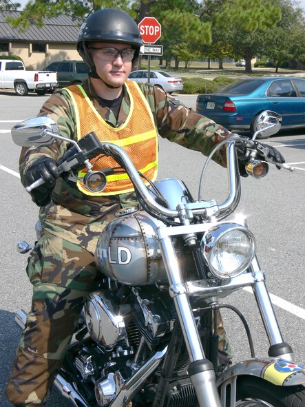Senior Airman Aaron Hatfield, 23rd Logistics Readiness Squadron, rides  his motorcycle that is custom-painted to resemble a B-17G aircraft. Airman Hatfield’s entry, The Volunteer, was selected as the new name for the base paper. (U.S. Air Force photo by Senior Airman Leticia Hopkins)