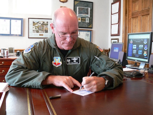 Col. Joe Callahan, 23rd Wing commander, signs a Combined Federal Campaign pledge sheet Monday to kick off this year’s campaign. The CFC combines more than 1,800 charities to ease the donation process for military members. (U.S. Air Force photo by Senior Airman S.I. Fielder)