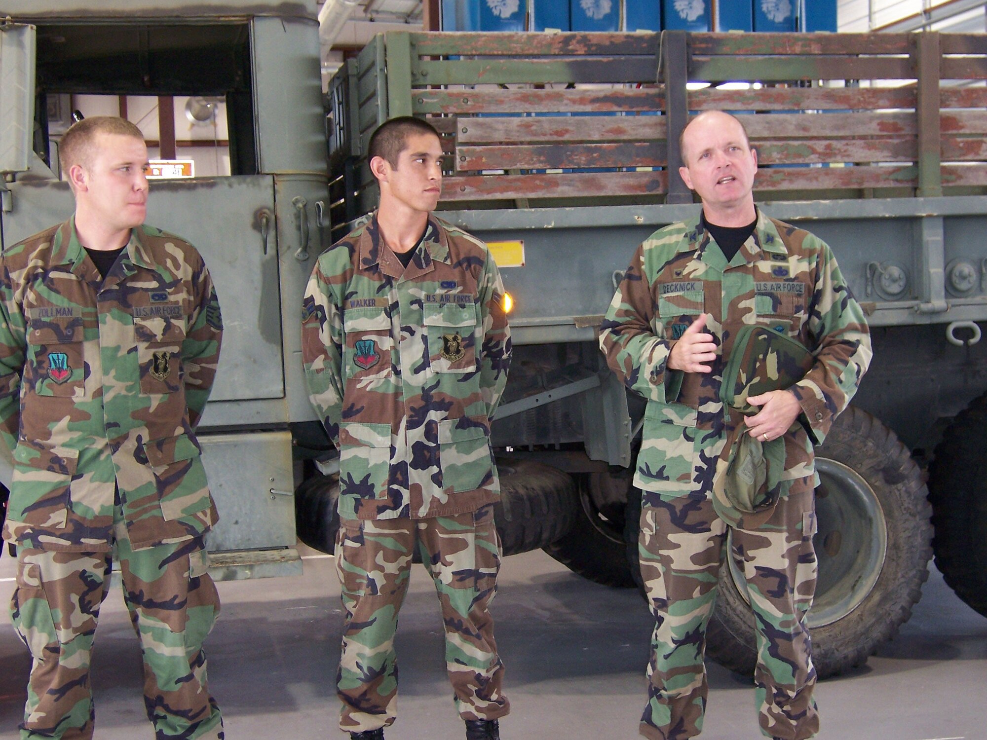 Staff Sgt. Jason Zollman and Airman 1st Class Adam Walker, 23rd Logistics Readiness Squadron, listen recently to Col. John Decknick, 820th Security Forces Group commander, express his gratitude for their efforts maintaining an 820th SFG M-35  troop transport / cargo truck. (Courtesy Photo)
