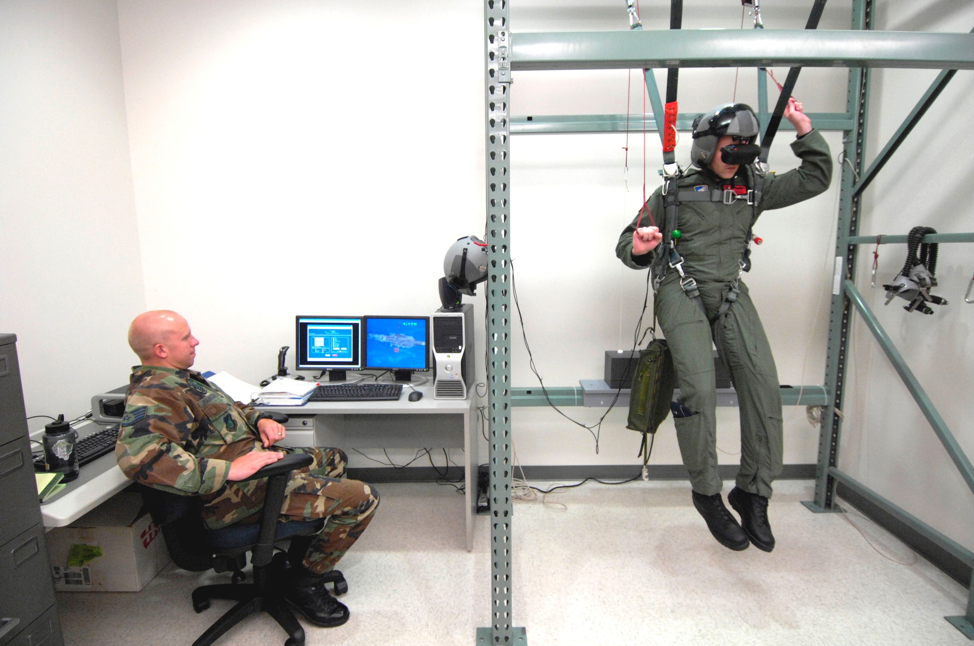 Staff Sgt. Matt Magnussen monitors 1st Lt. John Brantuk II progress as he steers his parachute during virtual training at Hickam Air Force Base, Hawaii, on Oct. 4. Sergeant Magnussen is a life support instructor with the 15th Operations Support Squadron. Lieutenant Brantuk is a pilot with the 535th Airlift Squadron. (U.S. Air Force photo/Tech. Sgt. Shane A. Cuomo)
