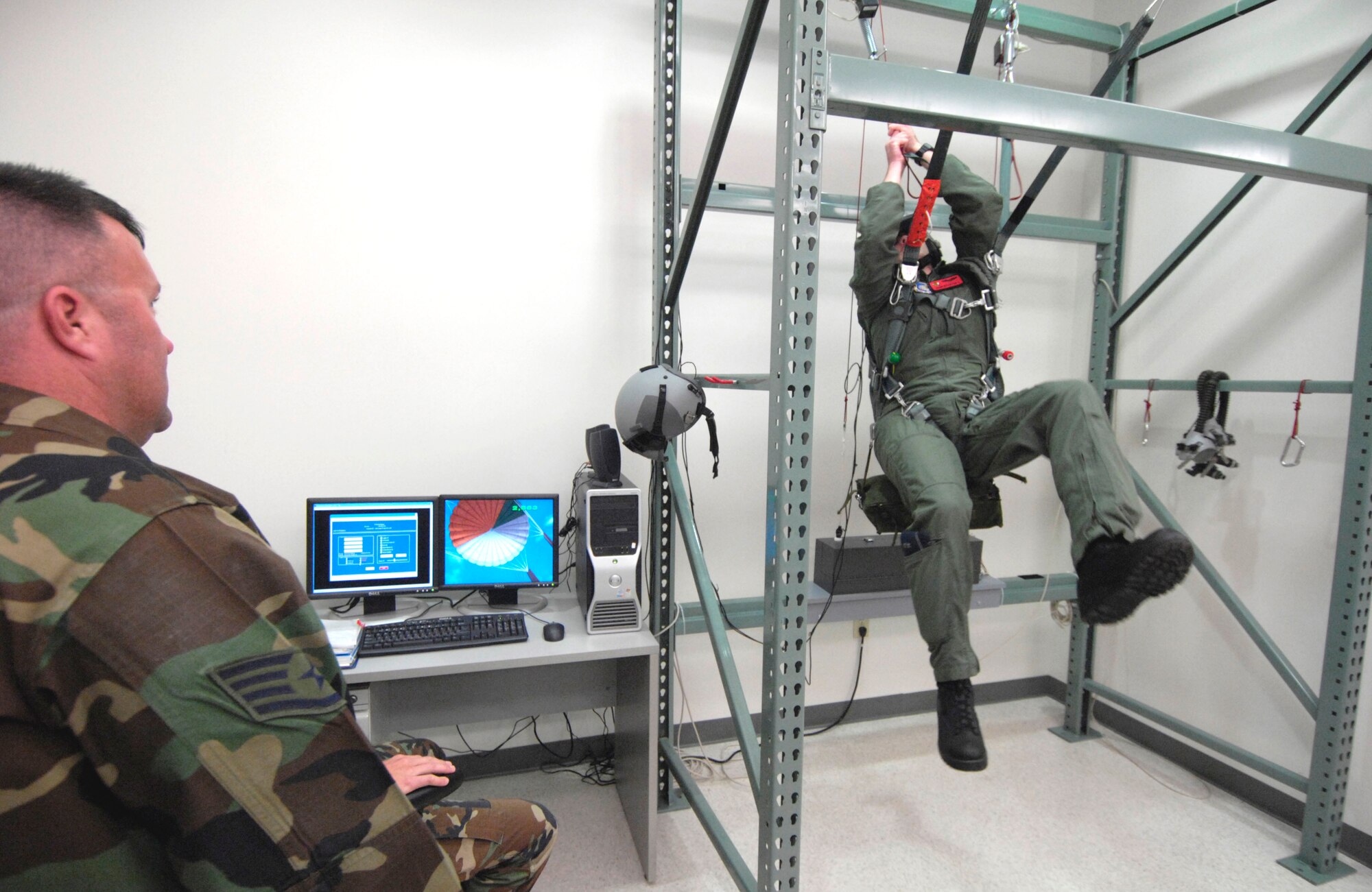 Staff Sgt. Christopher Ferguson watches as 1st Lt. John Brantuk II clears a malfunction on his parachute during virtual training at Hickam Air Force Base, Hawaii, on Oct. 4. Sergeant Ferguson is a survival, evasion, resistance and escape instructor with the 15th Operations Support Squadron. Lieutenant Brantuk is a pilot with the 535th Airlift Squadron. (U.S. Air Force photo/Tech. Sgt. Shane A. Cuomo)