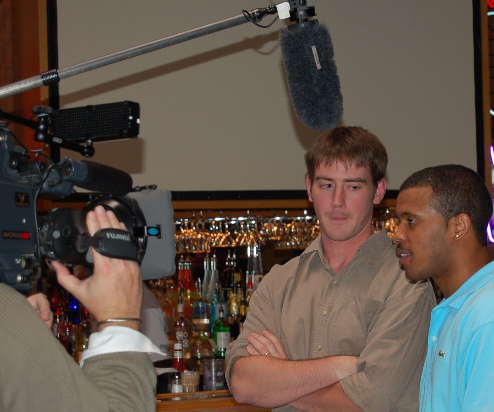 Senior Airman Milton Carrell (right) is interviewed before competing in the ESPN series, "NBA Live: Bring It Home" video game competition Oct. 3 in Grand Forks, N.D. Airman Carrell is assigned to the 319th Operation Support Squadron at Grand Forks Air Force Base. Standing with him is his opponent, Scott Price of Oakland, Calif. (U.S. Air Force photo/Airman 1st Class Ashley Coomes)