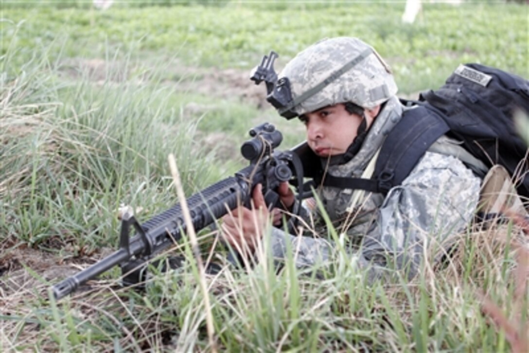 U.S. Army Pvt. Manuel provides security for fellow soldiers during a mission to root out insurgent forces in the Al Anbar province of Iraq on Sept. 27, 2006.  Manuel is assigned to the 2nd Battalion, 6th Infantry Regiment.  