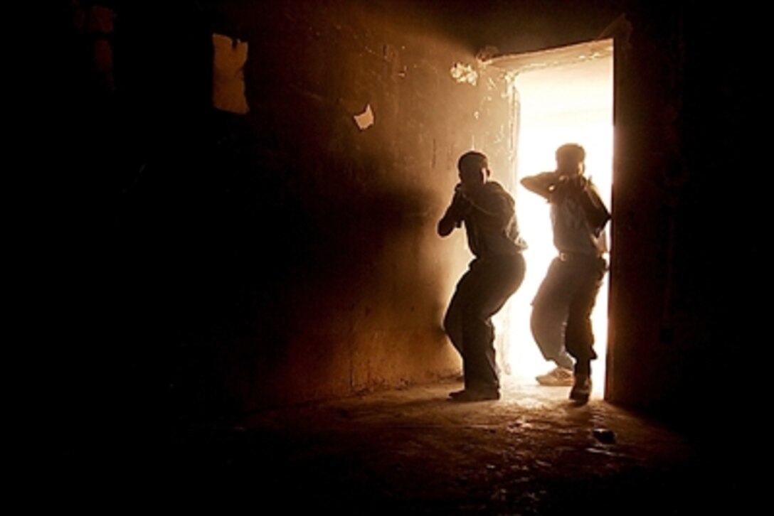 Iraqi police recruits participate in a close-quarters combat training at the Phoenix Academy in Ramadi, Iraq, Sept. 25, 2006. The exercise is the culmination of eight days of intense advanced training at the academy. 