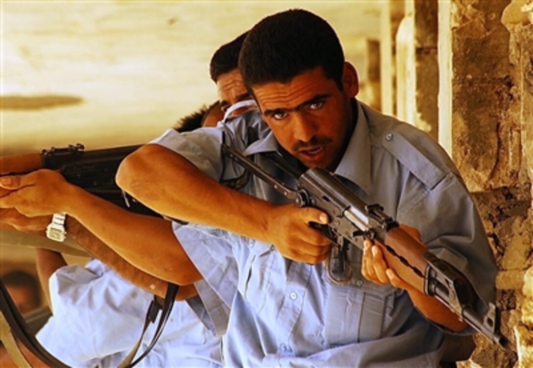 Iraqi police recruits prepare to enter a room during close-quarters combat training at the Phoenix Academy in Ramadi, Iraq, Sept. 25, 2006. The exercise is the culmination of eight days of intense advanced training at the academy. 