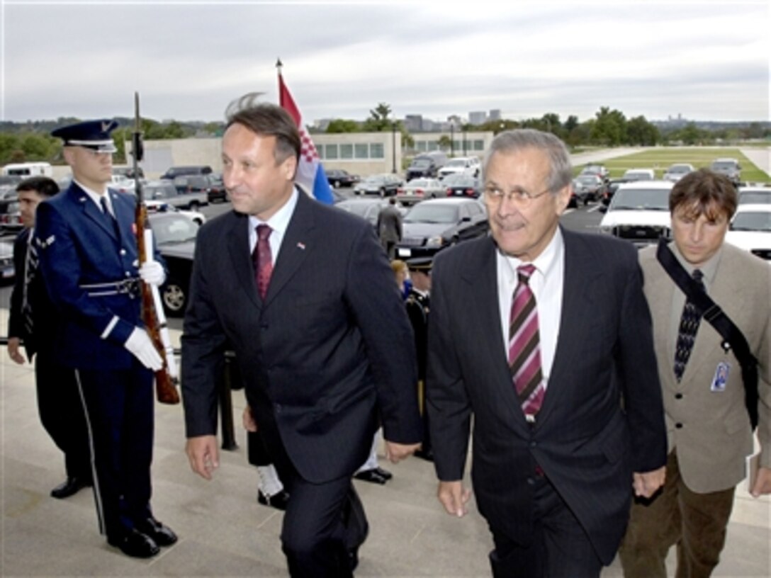Secretary of Defense Donald H. Rumsfeld (right) escorts Croatian Minister of Defense Berislav Roncevic (left) through an honor cordon and into the Pentagon on Oct. 5, 2006.  Rumsfeld and Roncevic will hold bilateral security discussions on a variety of global and regional issues.  