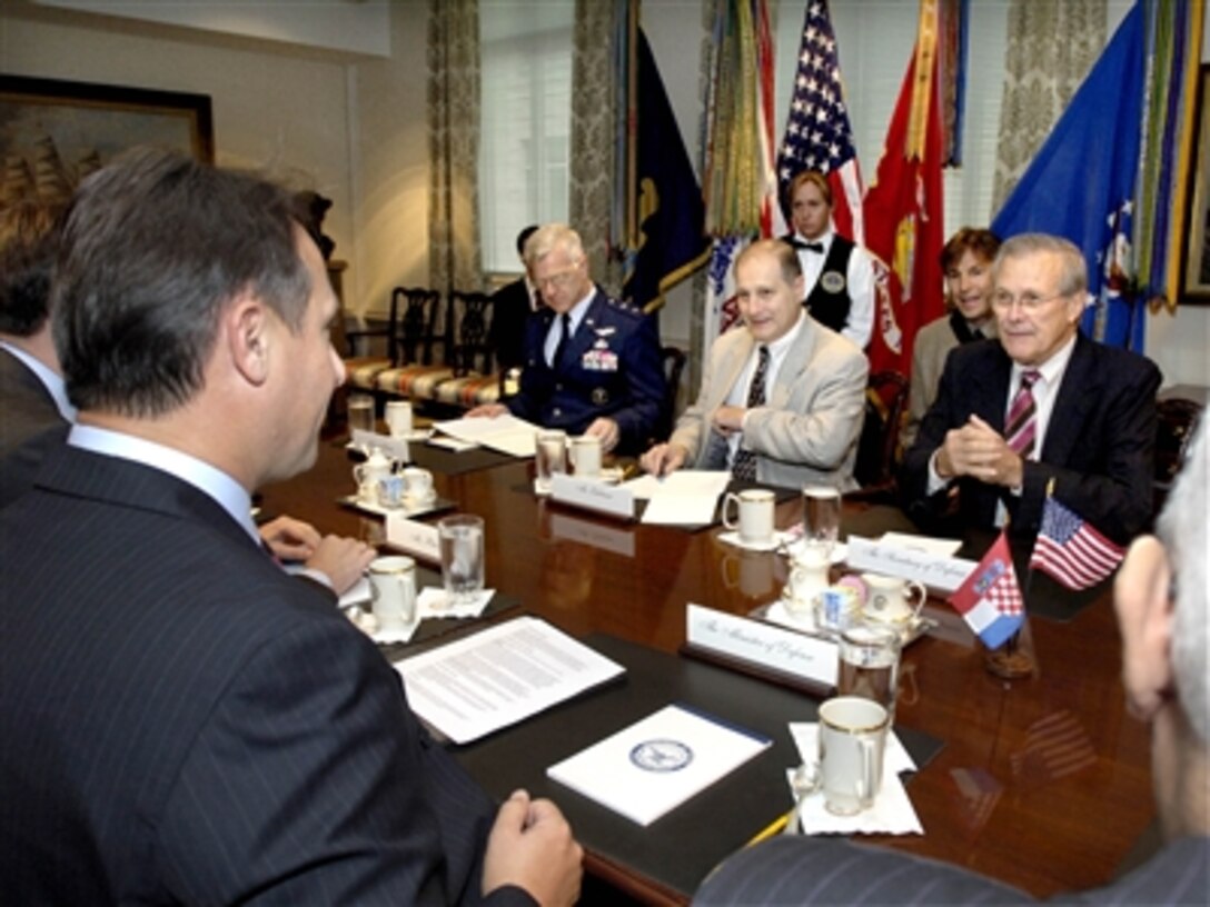 Secretary of Defense Donald H. Rumsfeld (right) hosts a Pentagon meeting with a Croatian delegation led by Minister of Defense Berislav Roncevic (left).  Also participating in the talks are Vice Director of the General Staff Maj. Gen. Scott Custer (2nd from left) and Under Secretary of Defense for Policy Eric Edelman (center).  Rumsfeld and Roncevic are holding bilateral security discussions on a variety of global and regional issues.    