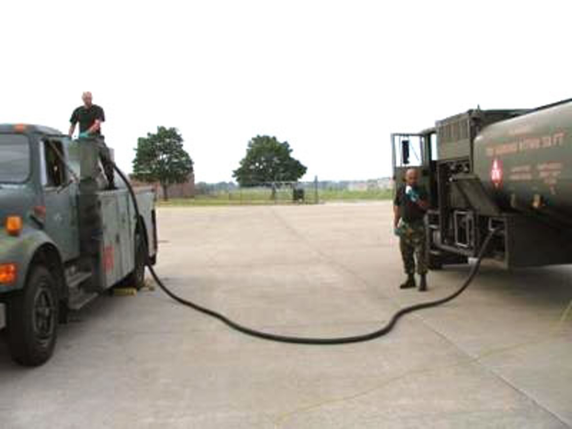 An R-11 fueler at Selfridge Air National Guard Base, Mich., pumps synthetic S8 FT fuel into another vehicle that normally runs on JP-8 jet fuel. The Air Force Advanced Power Technology Office at Robins Air Force Base, Ga., is developing a synthetic fuel for use in ground vehicles. (U.S. Air Force photo) 