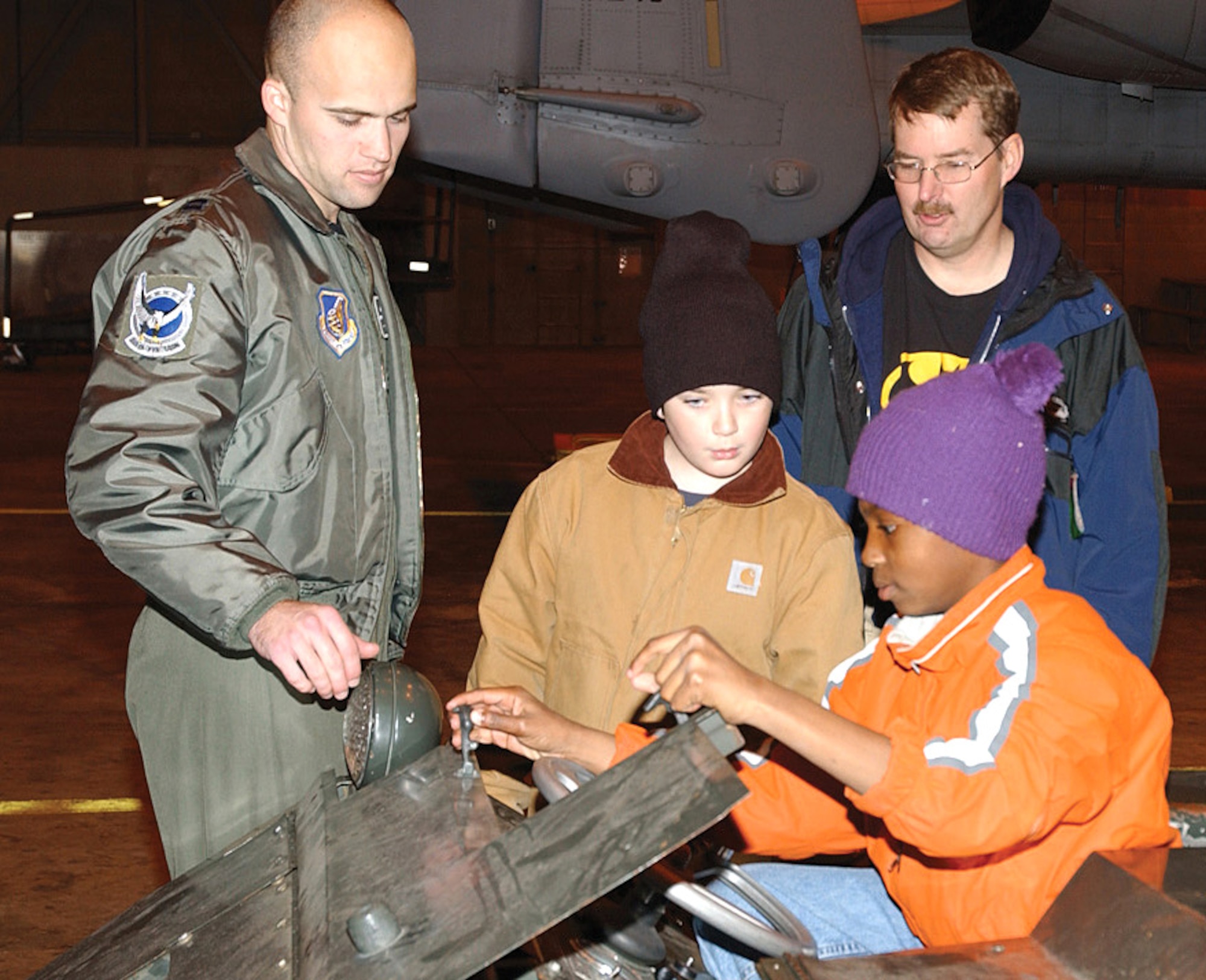 Capt. Travis Burton explains the functions of an MJ-1 vehicle used to load munitions onto aircraft Sept. 30 at Eielson Air Force Base, Alaska. The captain is a pilot with the 355th Fighter Squadron. (U.S. Air Force photo/Amn. Christopher Griffin)