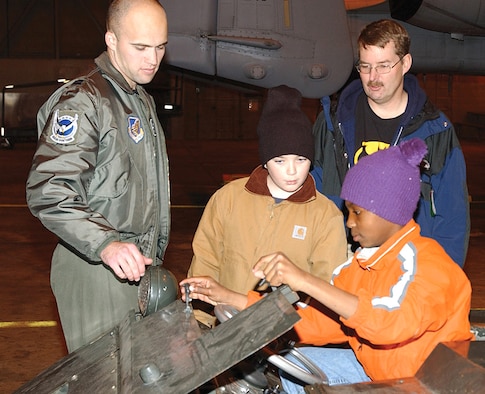 Capt. Travis Burton explains the functions of an MJ-1 vehicle used to load munitions onto aircraft Sept. 30 at Eielson Air Force Base, Alaska. The captain is a pilot with the 355th Fighter Squadron. (U.S. Air Force photo/Amn. Christopher Griffin)