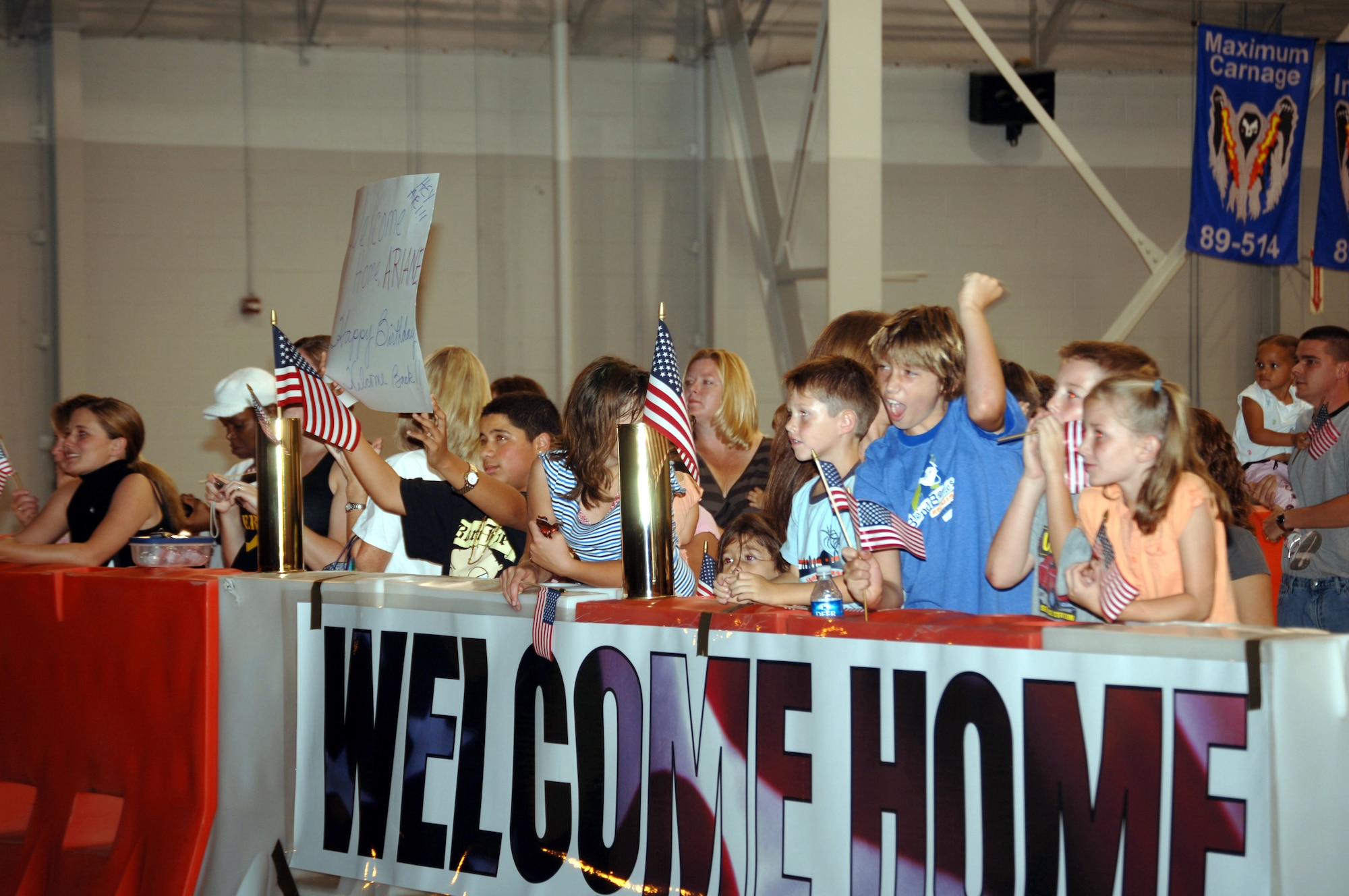 Family members cheer the arrival of their returning loved ones Monday night in Commando Hanger during the first Operation Homecoming.  More than 200 Hurlburt Field and Eglin Air Force Base Airmen returned home from Southwest Asia. (U.S. Air Force Photograph by Senior Airman Andy Kin)