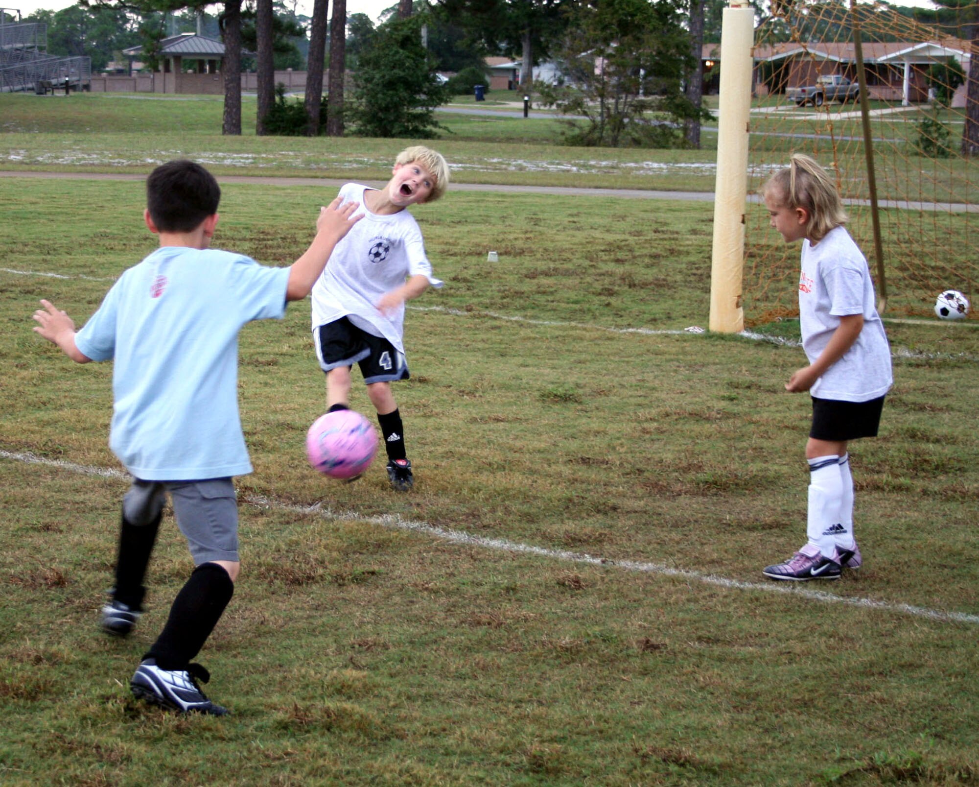 Austin Kaiser (center) practices passing the ball with fellow youth soccer enthusiasts during practice at the community park on base Oct. 2. (U.S. Air Force Photogragh by Jamie Haig)