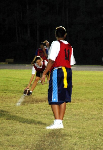 Players from the Tigers women's intramural flag football team take the offensive during their game against the Kiss My Pass team here Oct. 2.  Kiss My Pass defeated the Tigers 21--18.  (U.S. Air Force Photograph by Jamie Haig)