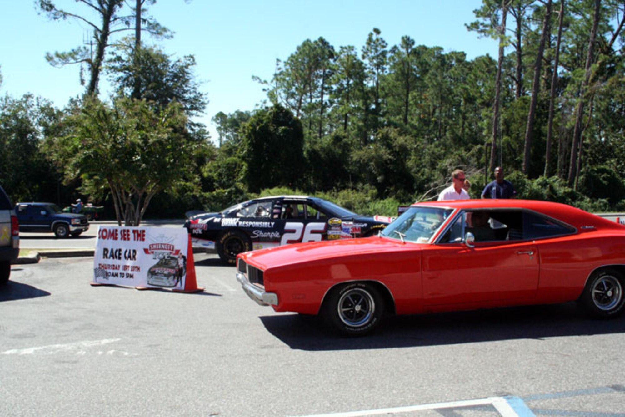 NASCAR driver Jamie McMurray and his car, #26, appeared at the shoppette Sept. 29 along with a 1969 Dodge Charger.  Mr. McMurray was there as part of an Army & Air Force Exchange Service promotion. (U.S. Air Force Photograph by Dylan Laurie)