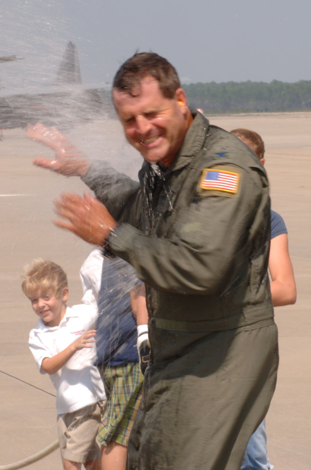 Col. Tim Minish, 16th Operations Group deputy commander, is sprayed after his final flight in a UH-1 Huey here Wednesday.  Colonel Minish will be retiring soon after 26 years of active-duty Air Force service. (U.S. Air Force Photograph by Senior Airman Andy Kin)