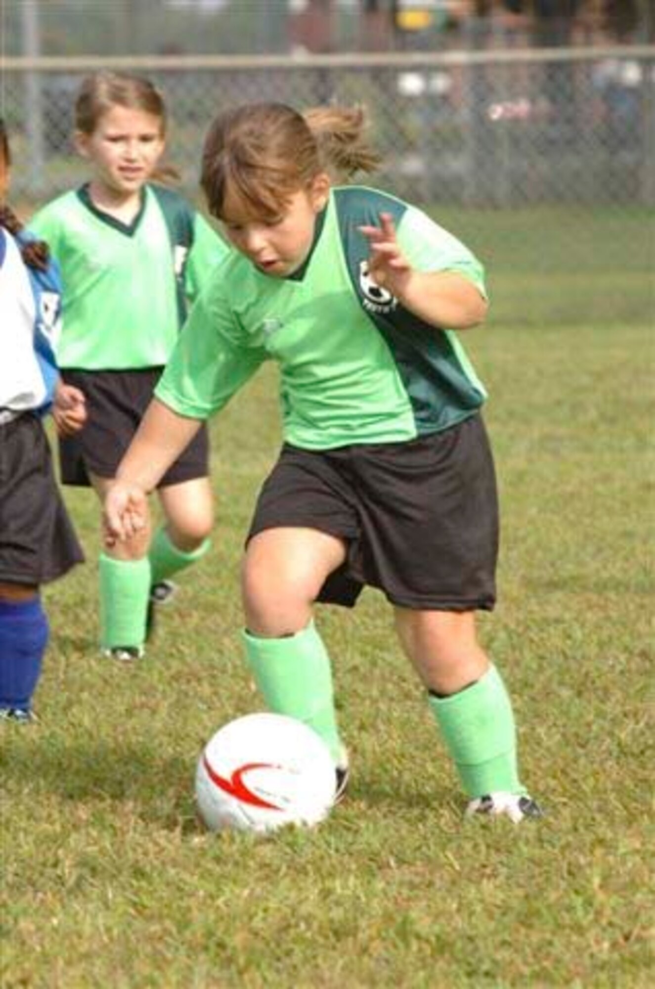 Ashley Knight, daughter of Staff Sgt. Robert and Kelly Knight, dribbles the ball downfield in a Seymour Johnson youth soccer game Saturday. (Photo by Tech. Sgt. Charles Tubbs)