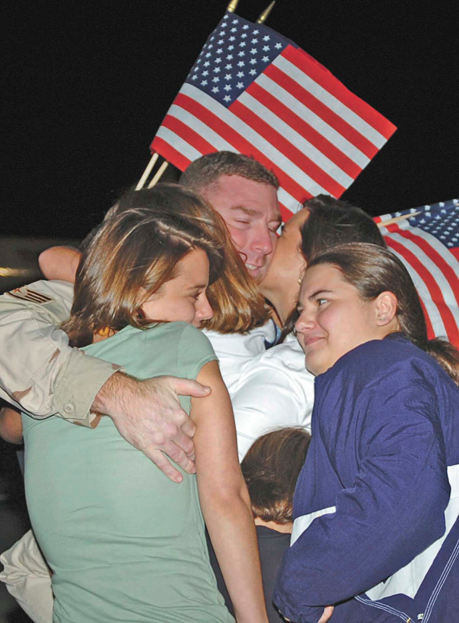 An Airman receives a warm welcome at the base fire station upon return from a four-month deployment.  More than 120 Airmen from various squadrons here returned Sept. 28 from their deployments in Southwest Asia. (Photo by Senior Airman Mickey Bazaldua)