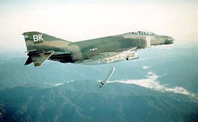 McDonnell Douglas F-4C-23-MC (S/N 64-762) in flight dropping Cluster Bomb Unit dispenser over the A Shau Valley, South Vietnam, on June 23, 1967. (U.S. Air Force photo)