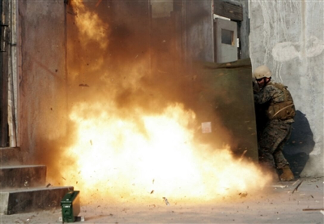 U.S. Marines being trained by III Marine Expeditionary Force's Special Operations Training Group, detonate a slider charge during the Dynamic Entry Course held on Camp Hansen's rifle range in Okinawa, Japan, Sept. 19, 2006.