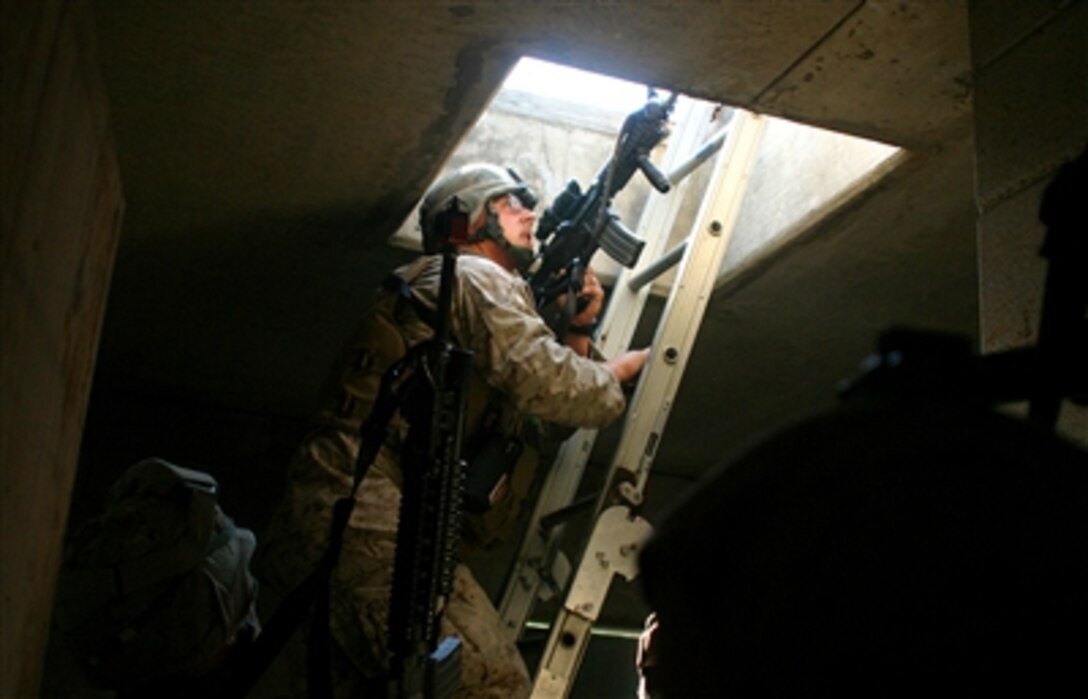 U.S. Marine Cpl. Robert L. Sullivan of 2nd Marine Regiment, 26th Marine Expeditionary Unit, climbs a ladder to get to a suspected gun man that fired a simulated rocket propelled grenade during the Military Operation in Urban Terrain course at Fort Pickett, Va., Sept. 28, 2006. 
