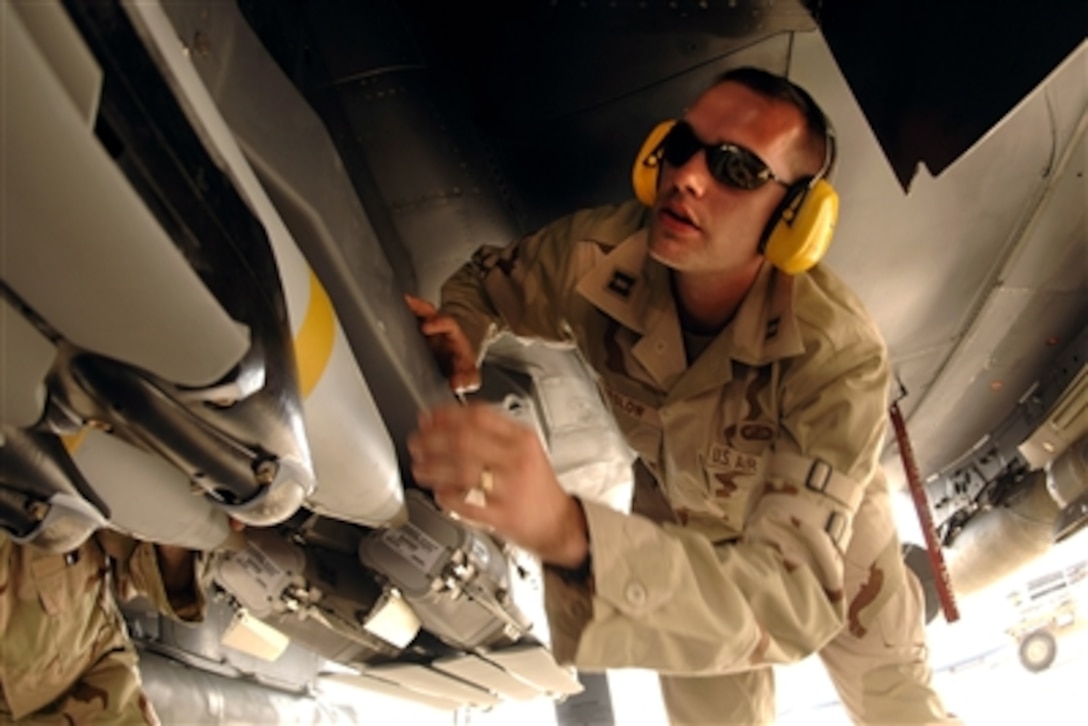 U.S. Air Force Capt. Jim Parslow, Small Diameter Bomb Systems Flight commander, inspects a weapons carriage with GBU-39/B small diameter bombs mounted on an F-15E Strike Eagle at a forward-operating location, Oct. 4, 2006.