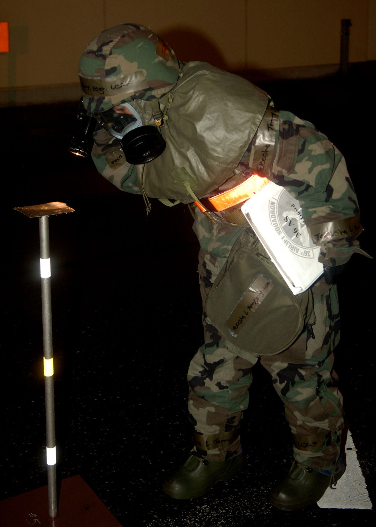 Staff Sergeant Tekesha Terry checks for possible signs of contamination while on a post-attack sweep during an exercise at Yokota Air Base, Japan.  The 374th Air Wing was conducting the exercise to test Airmen's responses to chemical or biological hazards.  Sergeant Terry is with the 36th Airlift Squadron.  (U.S. Air Force photo/Senior Airman Veronica Pierce)