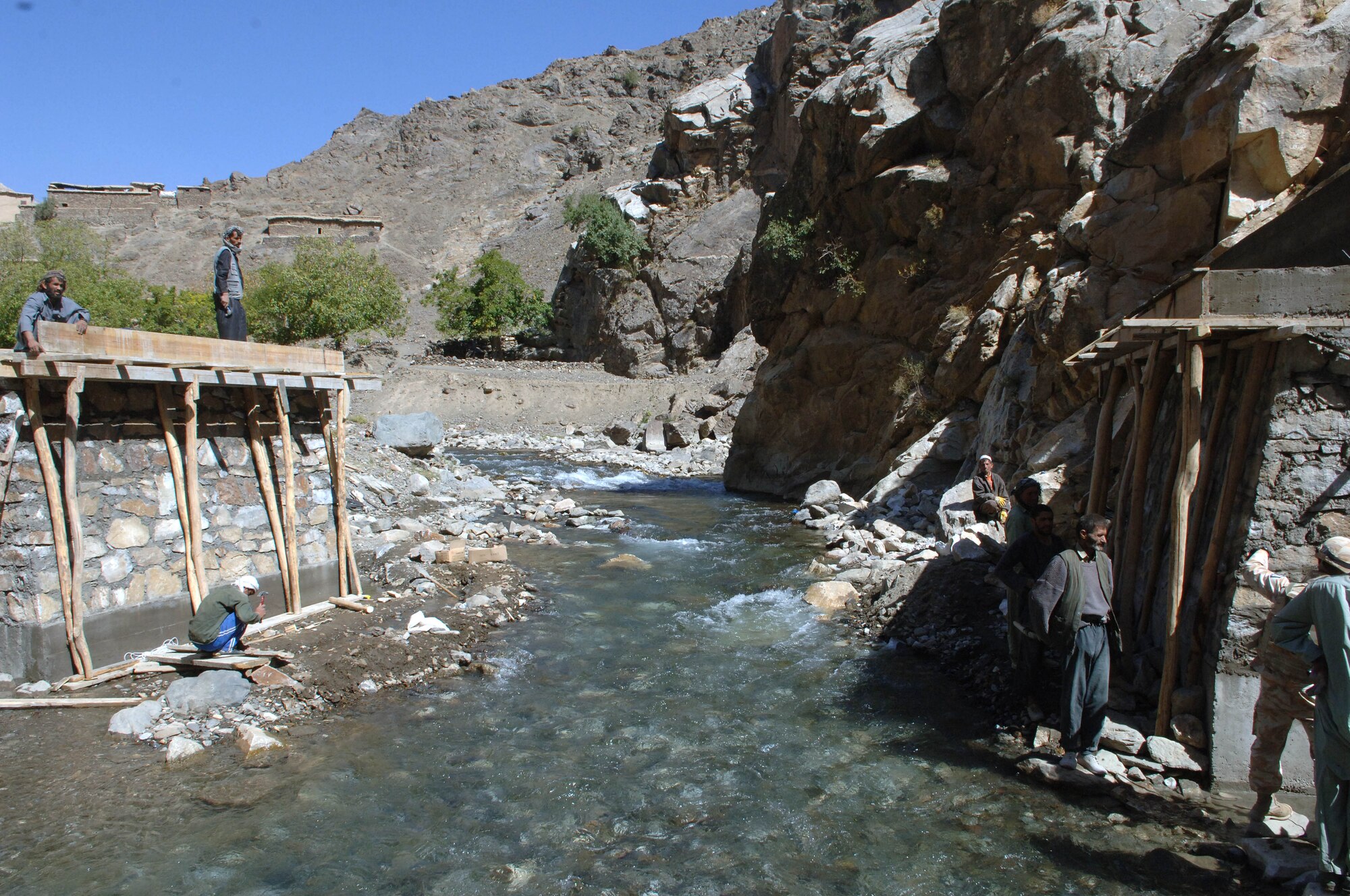 Afghans in the Salang Valley work to complete one of two bridges in the area.  The Air Force-led Bagram PRT will make history when the two final bridges are completed allowing vehicle traffic into the valley all year round. (U.S. Air Force photo/Tech. Sgt. Joseph Kapinos)