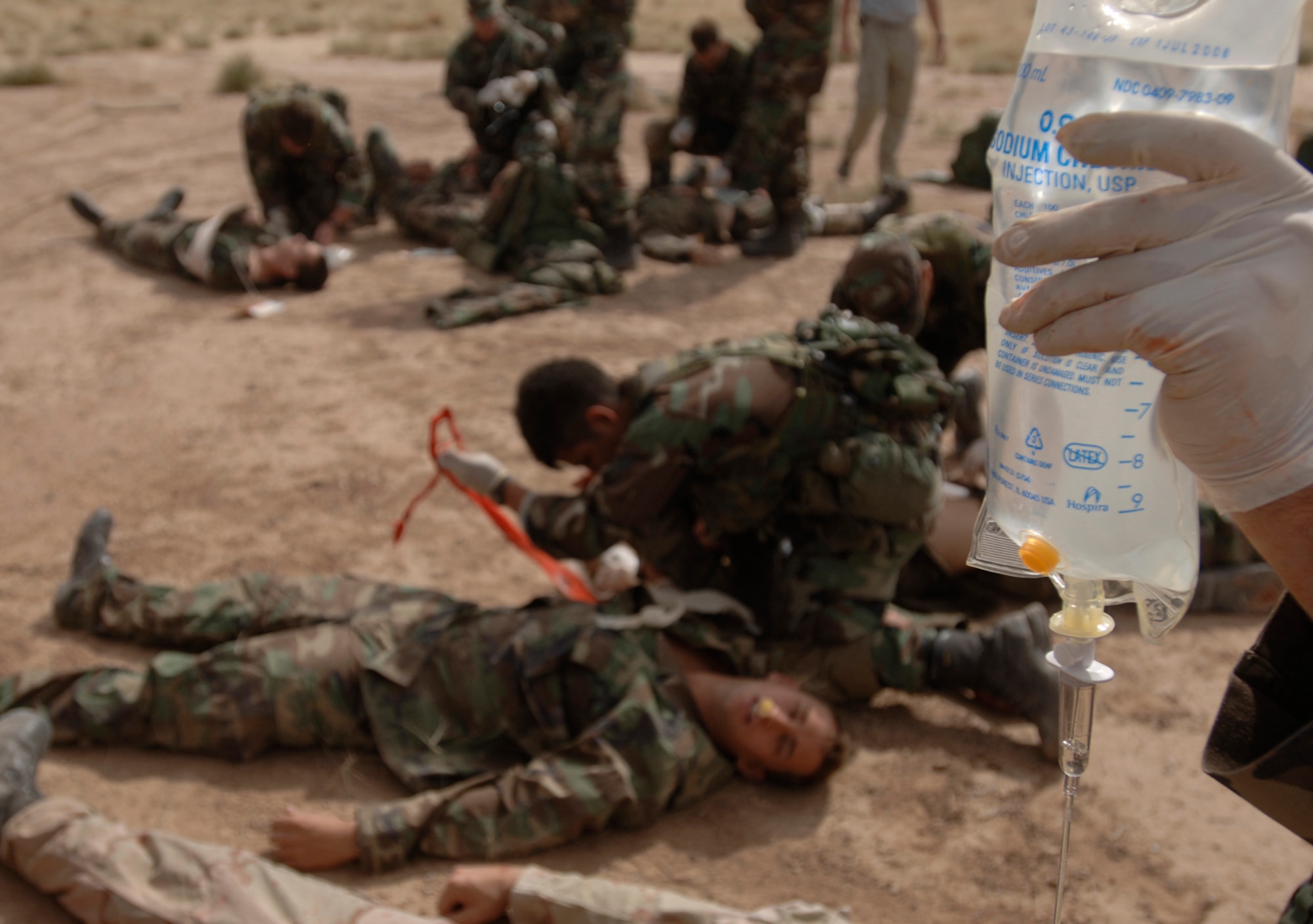 Pararescue trainees insert an intravenous catheter while performing life-saving techniques on simulated casualties during an exercise at Kirtland Air Force Base, N.M., Oct. 6. The exercise is part of the pararescue recovery specialist course at the Pararescue and Combat Rescue Officer School. (U.S. Air Force photo/Tech. Sgt. Cecilio Ricardo Jr.)