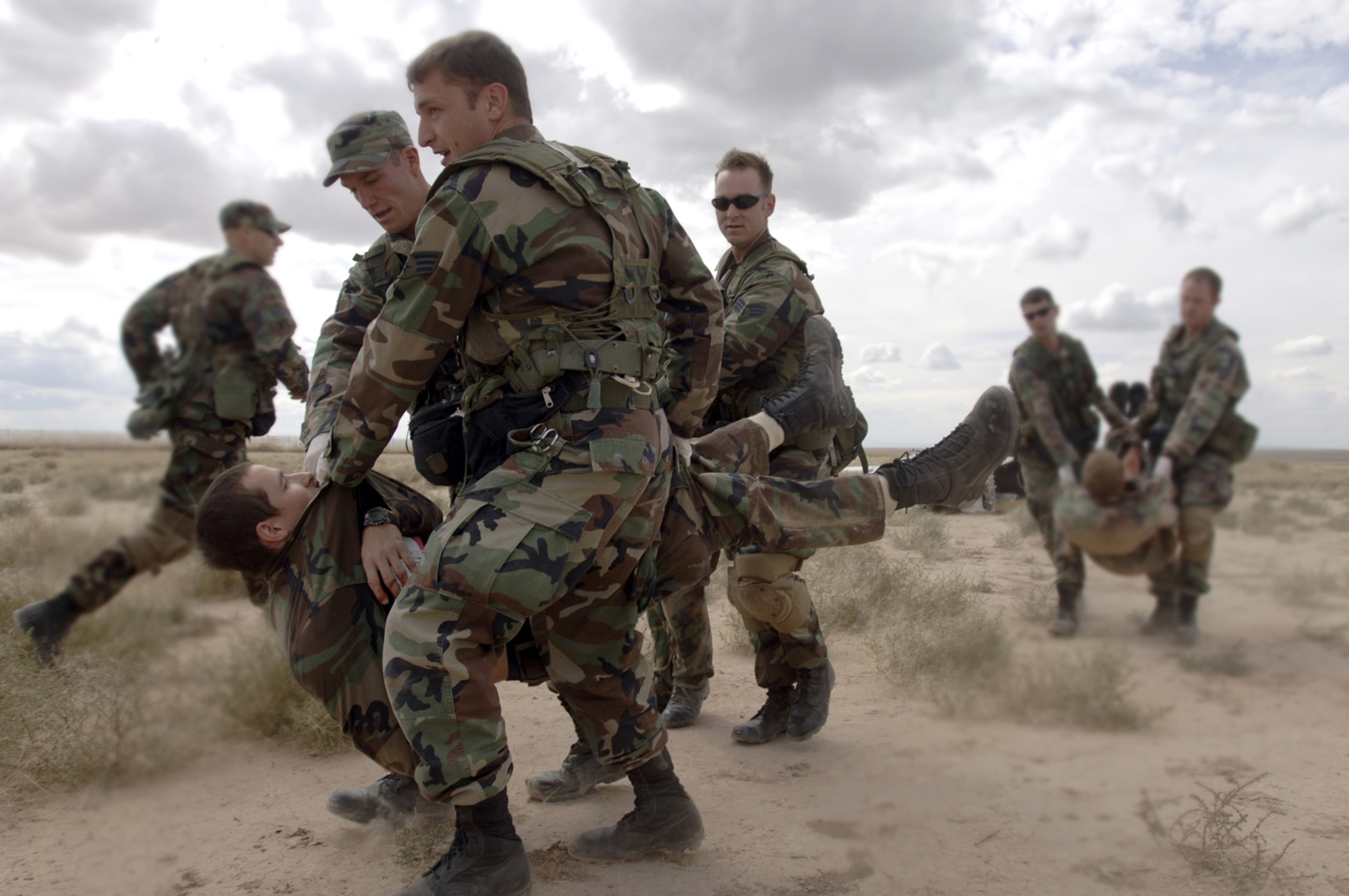 (From left) Airmen 1st Class Mark Finney, Art Boyd and Josh Frost carry Airman 1st Class Matthew Macella during a mass casualty incident exercise at Kirtland Air Force Base, N.M., Oct. 6. The exercise is part of the pararescue recovery specialist course at the Pararescue and Combat Rescue Officer School. (U.S. Air Force photo/Tech. Sgt. Cecilio Ricardo Jr.)