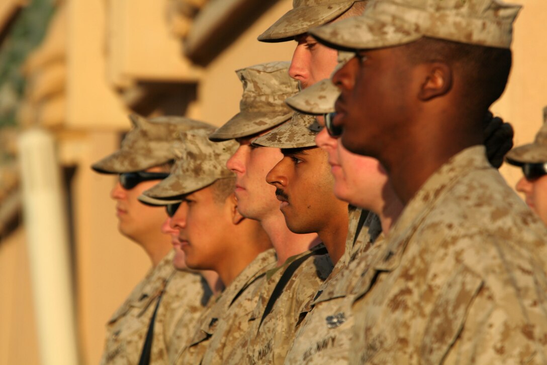 Marines in formation stand at attention during the transfer-of-authority ceremony at Al Asad, Iraq, Oct. 7. Marine Heavy Helicopter Squadron 363, Marine Aircraft Group 16 (Reinforced), 3rd Marine Aircraft Wing (Forward), assumed the responsibilities of assault support from HMH-463, MAG-16.