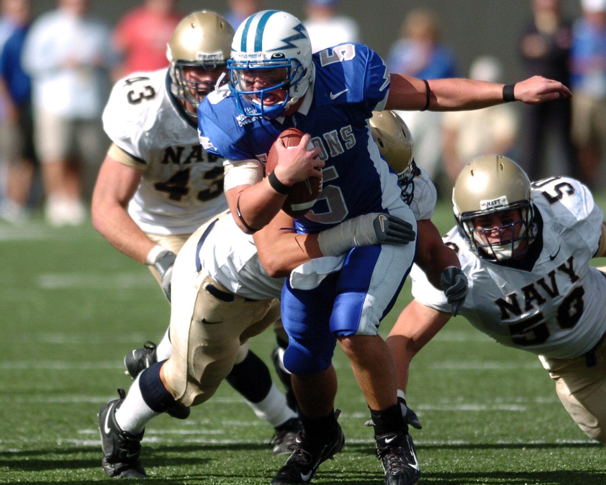Air Force quarterback Shaun Carney breaks through Navy tacklers Saturday to scramble back to the original scrimmage line and avoid a fourth-quarter sack. Carney rushed for 57 of the Falcons’ 193 total yards on the ground.  Navy won, 24-17. (Photo by 1st Lt. John Ross)