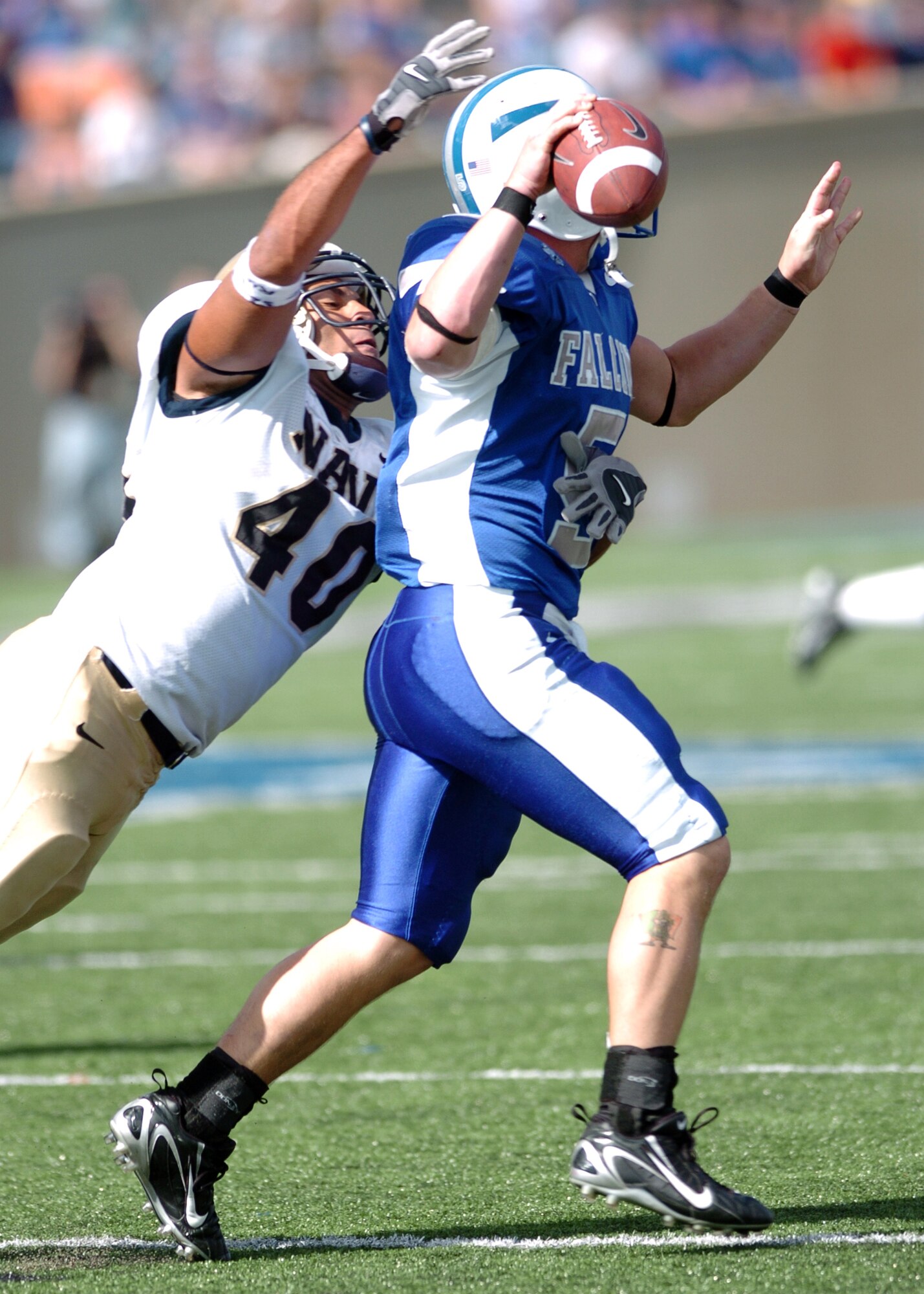 Navy outside linebacker David Mahoney knocks the ball from Air Force quarterback Shaun Carney’s hand Saturday in a third-quarter sack. Mahoney led Navy with 3 sacks on the day for 12 yards.  Navy won, 24-17 (Photo by 1st Lt. John Ross)