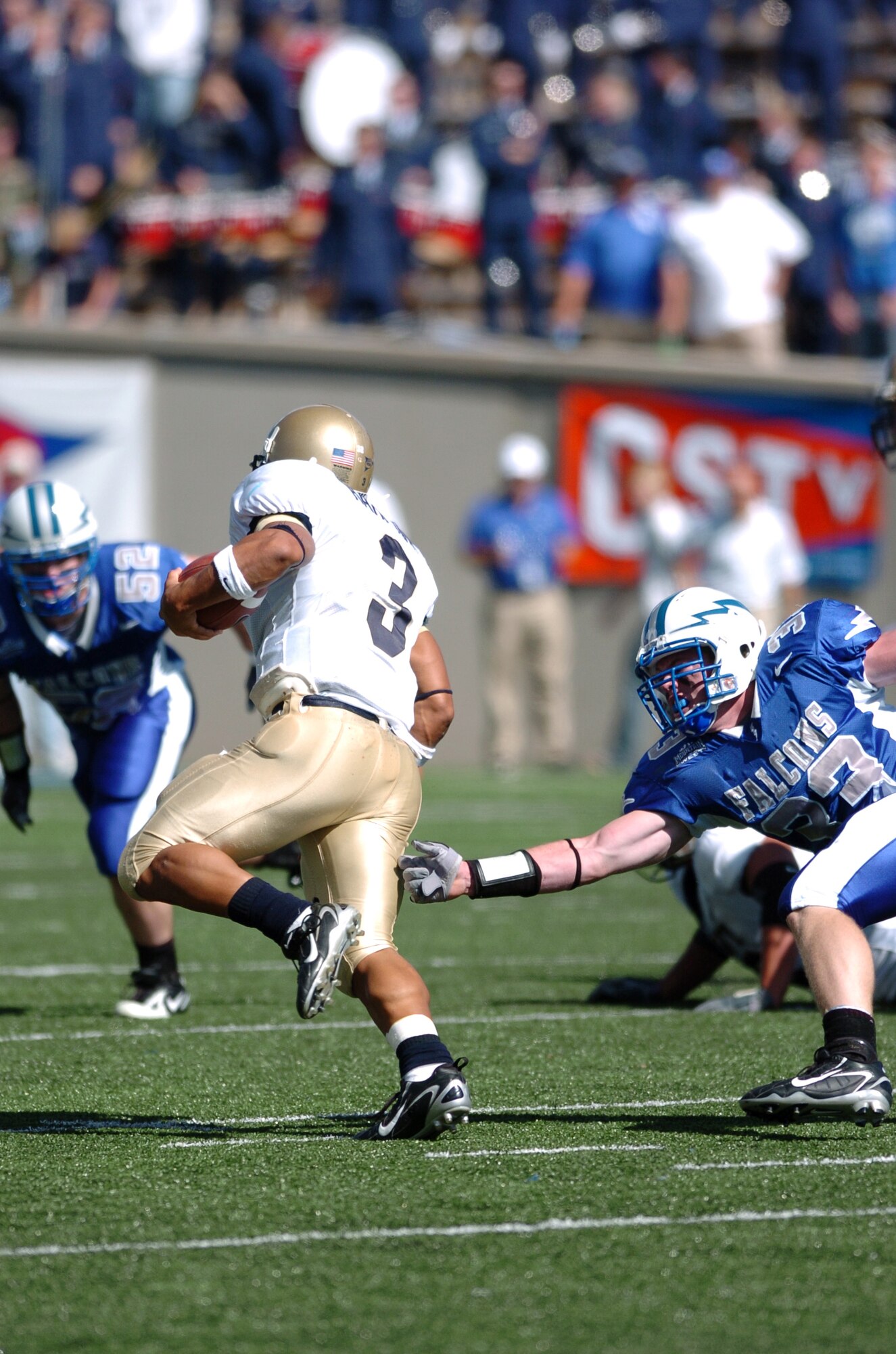 Navy quarterback Brian Hampton eludes Air Force linebacker Drew Fowler Saturday for a short second-quarter gain.  Hampton ran for 111 of Navy’s 317 rushing yards in their 24-17 win over the Falcons.  (Photo by 1st Lt. John Ross)
