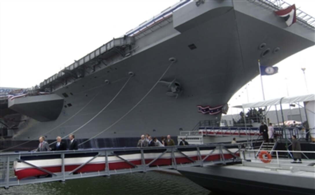 Former President George H. W. Bush, U.S. President George W. Bush, and Governor Jeb Bush, leave together after the christening ceremony of the USS George H.W. Bush at Northrop Grumman's shipyard in Newport News, Va., Oct. 7, 2006. 