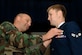 Chief Master Sergeant Troy Odden places the new 3e9x1 Occupational Badge on Airman 1st Class Ian Zerby of  Langley Air Force Base for the very first time on September 29, 2006.  U.S. Air Force photo by Airman 1st Class Vernon Young.