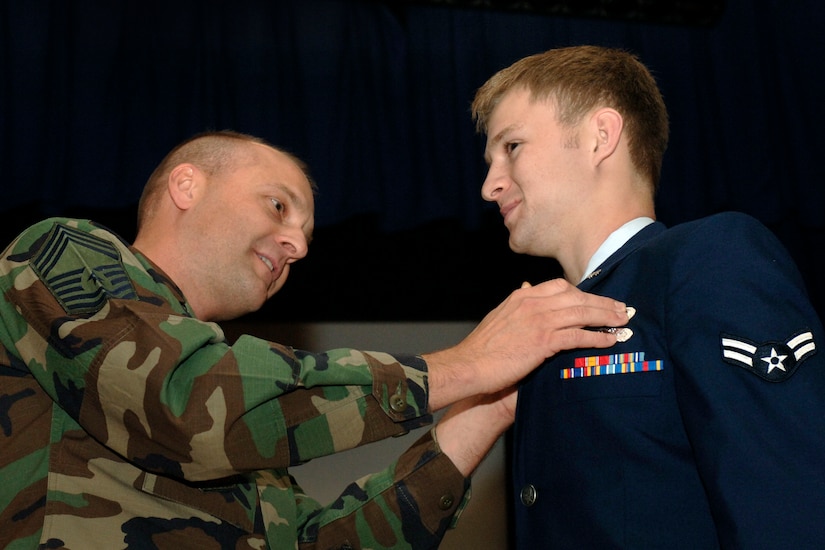 Chief Master Sergeant Troy Odden places the new 3e9x1 Occupational Badge on Airman 1st Class Ian Zerby of  Langley Air Force Base for the very first time on September 29, 2006.  U.S. Air Force photo by Airman 1st Class Vernon Young.