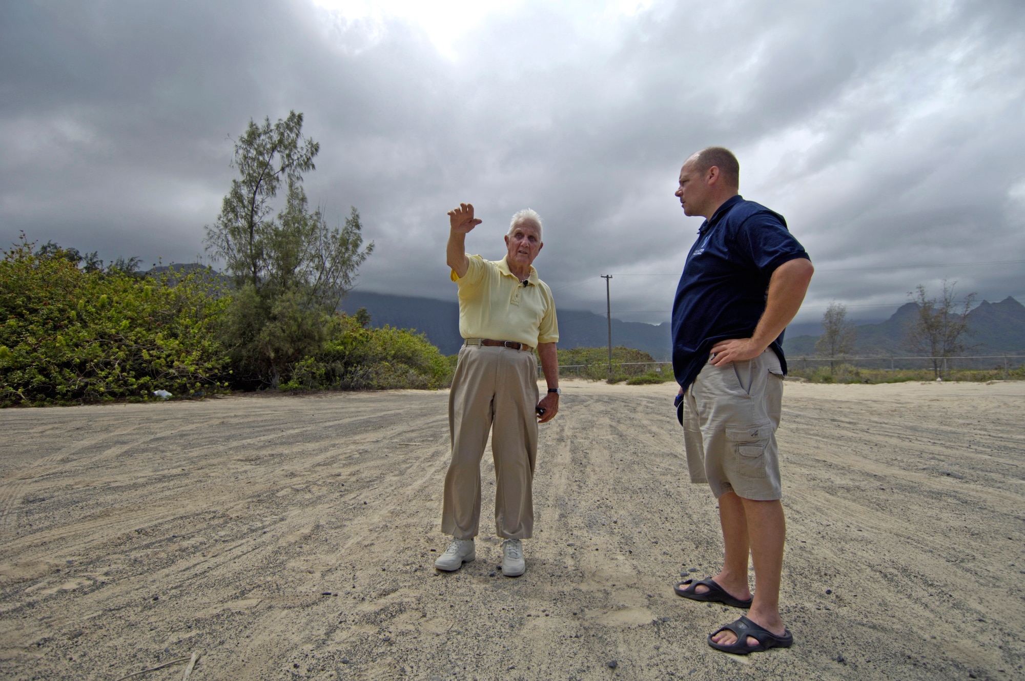 Raymond Stehle and Master Sgt. Robert Burgess stand on the old runway at Bellows Air Force Station Sept. 30 as Mr. Stehle explains where his gunners nest was. Mr. Stehle was stationed at Bellows Army Air Field when the Japanese attacked on Dec. 7, 1941. Sergeant Burgess is from the 15th Airlift Wing Public Affairs office at Hickam Air Force Base, Hawaii. (U.S. Air Force photo/Tech. Sgt. Shane A. Cuomo)