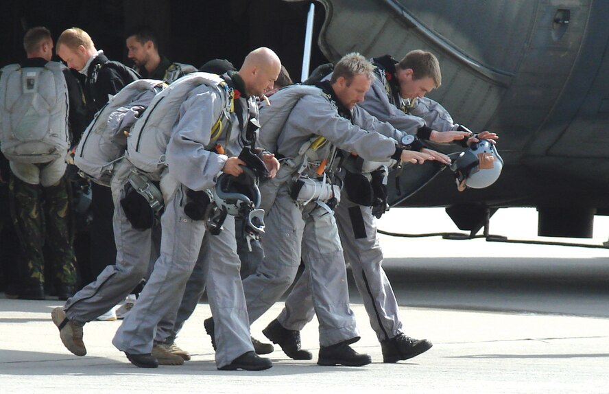 Members of the Danish Jaegerkorps rehearse airdrop procedures they will employ during high-altitude-low opening drops on the flight line in Aalborg, Denmark. (U.S. Air Force photo/Tech. Sgt. Anthony Petruzzi)                               