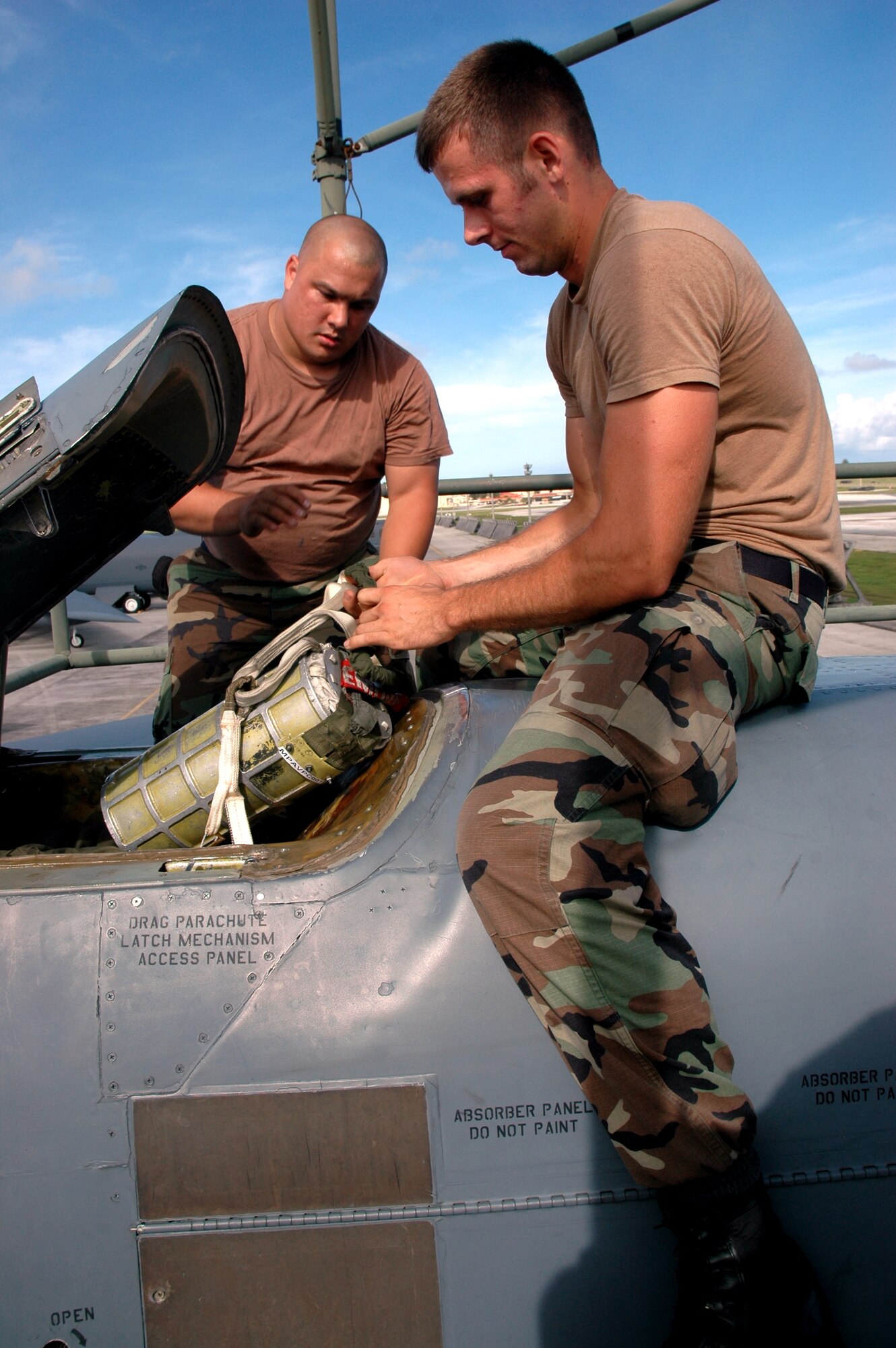 Staff Sgt. Kevin Arrington (left) and Senior Airman Tyson Reams install a drag chute canister on a B-52 Stratofortress Sept. 21 during aircraft recovery at Andersen Air Force Base, Guam. Both are crew chiefs with the 36th Expeditionary Aircraft Maintenance Squadron. The squadron has achieved 100 percent mission effectiveness and 100 percent weapons release rates since arriving in September. The Airmen are deployed to Andersen AFB as part of the United States' commitment to keeping a continuous bomber presence in the Pacific region. (U.S. Air Force photo/Staff Sgt. Eric Petosky) 