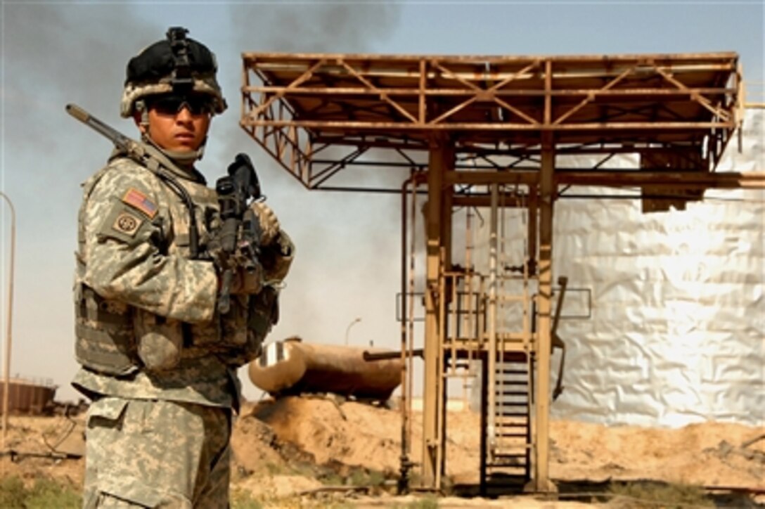 U.S. Army Sgt. Nathan McWalters provides security at an oil refinery in Qayyarah, Iraq, on Sept. 29, 2006.  McWalters is assigned to the 3rd Stryker Brigade Combat Team, 2nd Infantry Division.  