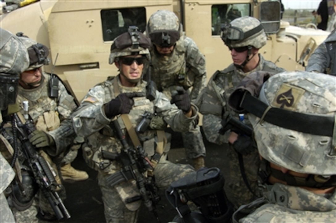 U.S. Army 1st Lt. Thomas Beyerl gives instructions to soldiers in his unit in the Adhamiyah area of northeast Baghdad, Iraq, on Oct. 2, 2006. The soldiers are assigned to Alpha Troop, 1st Squadron, 61st Cavalry Regiment, 506th Regimental Combat Team, 101st Airborne Division.  