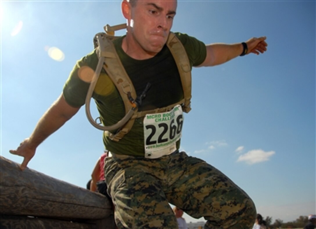 A participant in the Boot Camp Challenge jumps over an obstacle as part of San Diego Fleet Week at Marine Corps Recruit Depot, San Diego, Calif., Oct. 7, 2006.