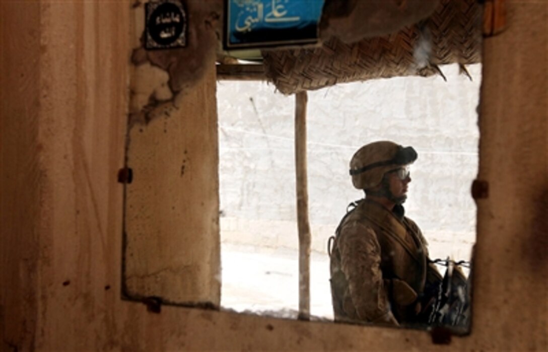 U.S. Navy Seaman Vincent E. Hurtado, a hospital corpsman with C Company, 1st Battalion, 25th Marine Regiment, Regimental Combat Team 5, helps to clear a home in Fallujah, Iraq, Oct. 3, 2006. Marines recently conducted search operations to confirm or deny the presence of anti-Iraqi forces operating in the souk district. 