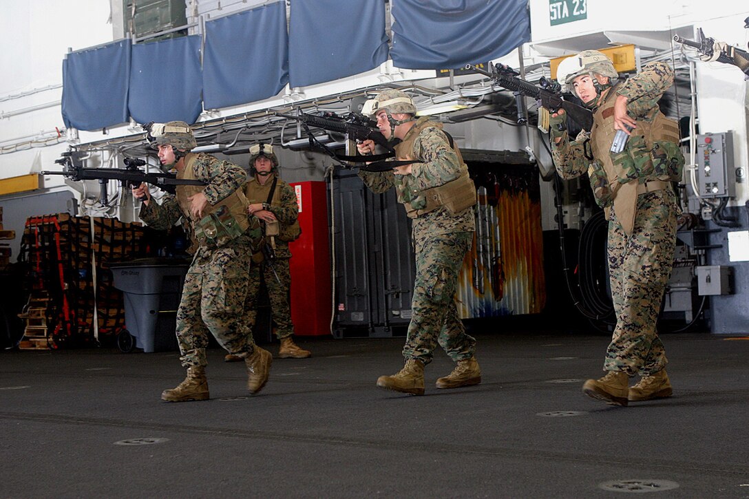 ABOARD USS BOXER (Sept. 29, 2006) -- Marines with 4th Platoon, Echo Co., Battalion Landing Team 2/4, 15th Marine Expeditionary Unit (Special Operations Capable) reload their weapons during immediate action drills in the hangar bay. Marines with 4th Plt., Echo 2/4 are participating in the drills to become more proficient in their quick reloading. The 15th MEU (SOC) is currently on a deployment thru the Western Pacific region. (Official USMC photo by Cpl. Thomas J. Grove) (Released)